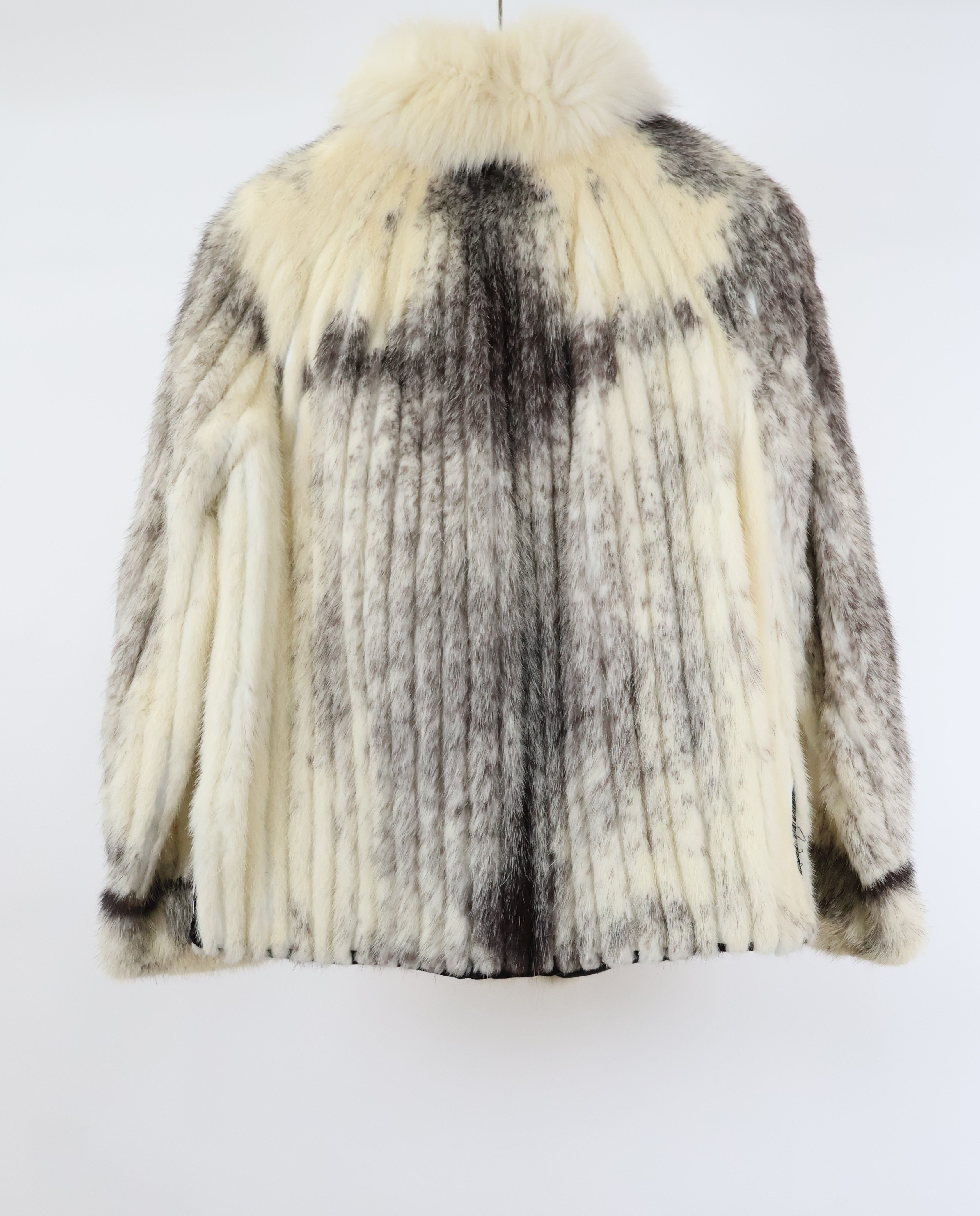 PRE-OWNED BLACK CROSS RIBBED MINK JACKET W/ WHITE FOX TUXEDO FRONT, BANDED CUFFS & SIDE SLITS